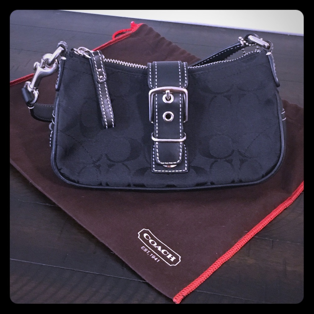 Small size Coach signature canvas purse.